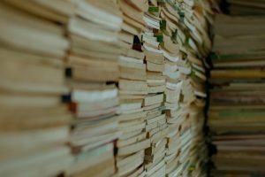 Close-up of stacked vintage paperbacks creating a textured, historical ambiance.